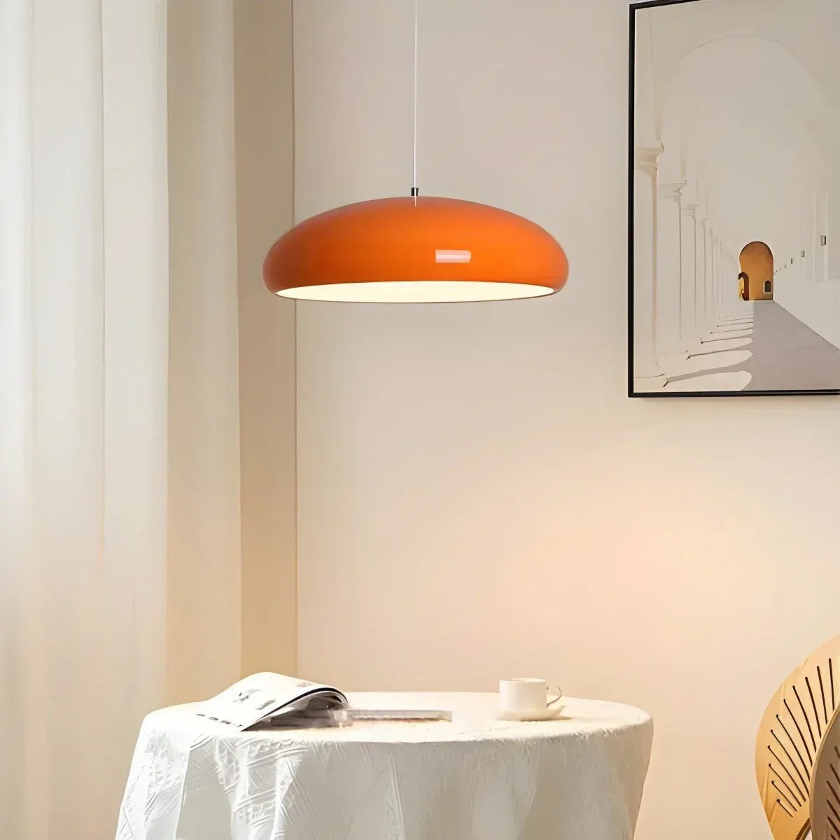 Orange Lola glossy dome pendant light above a round dining table