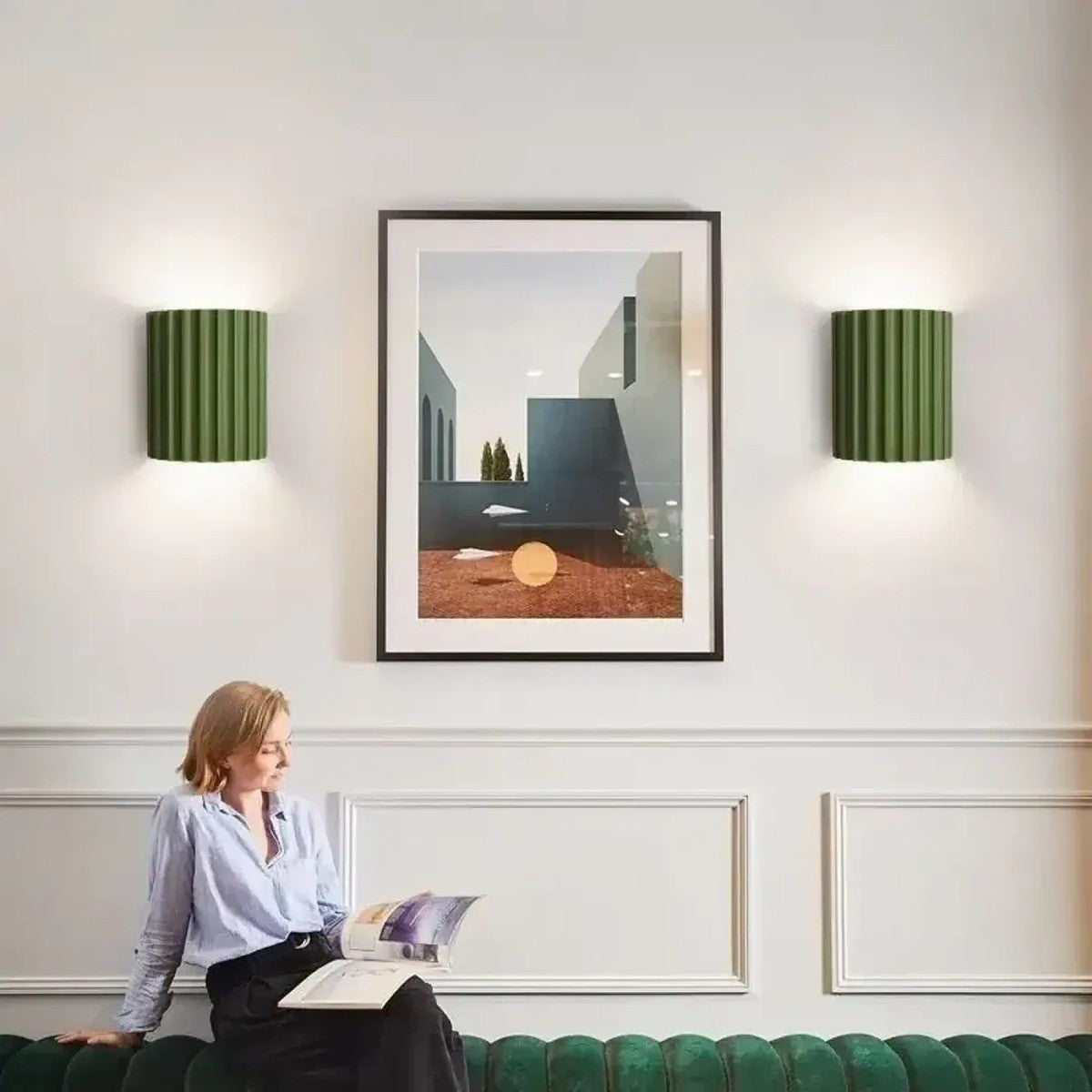 Pair of green Nell fluted wall sconces framing artwork in a living room