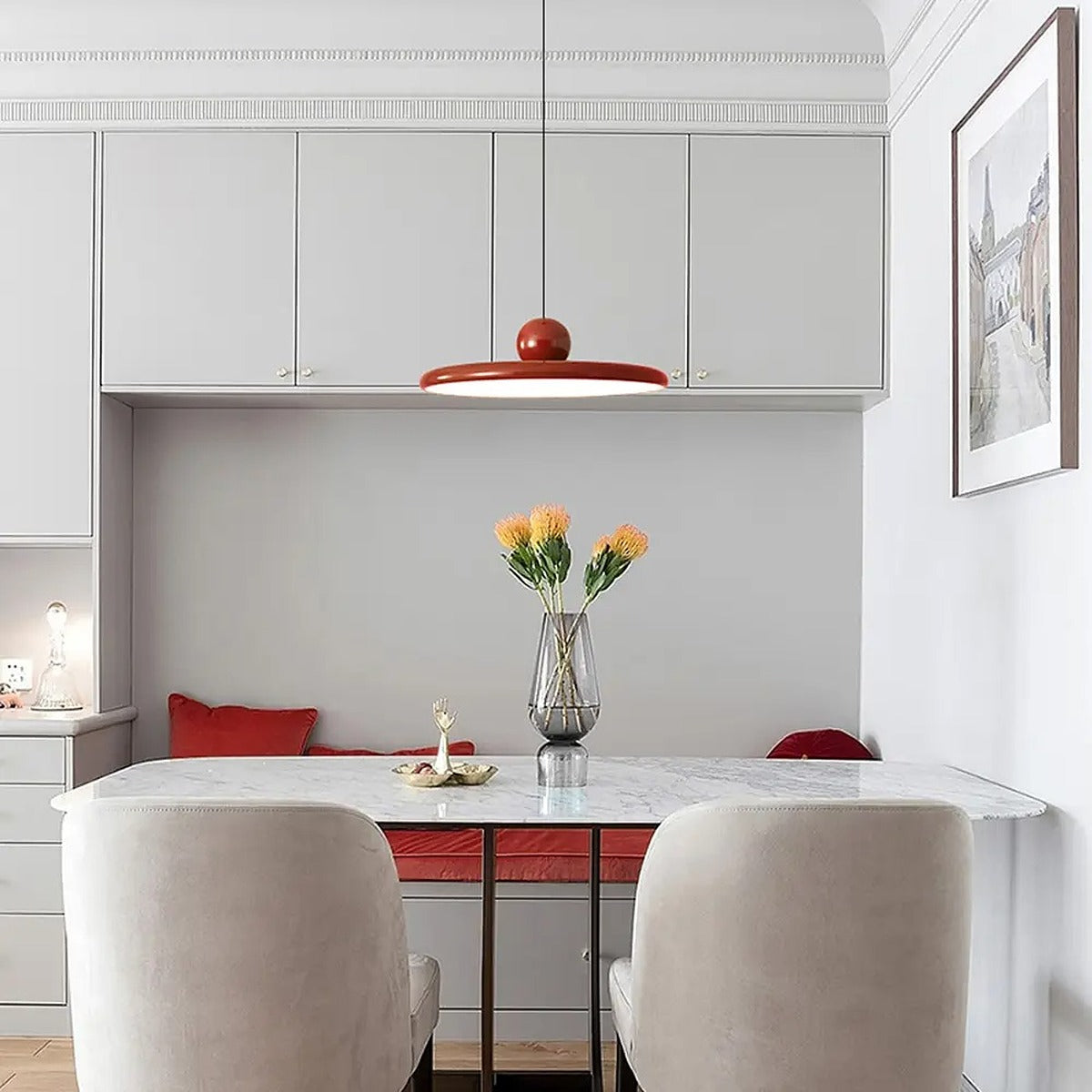 Red Juno saucer pendant light above a kitchen banquette