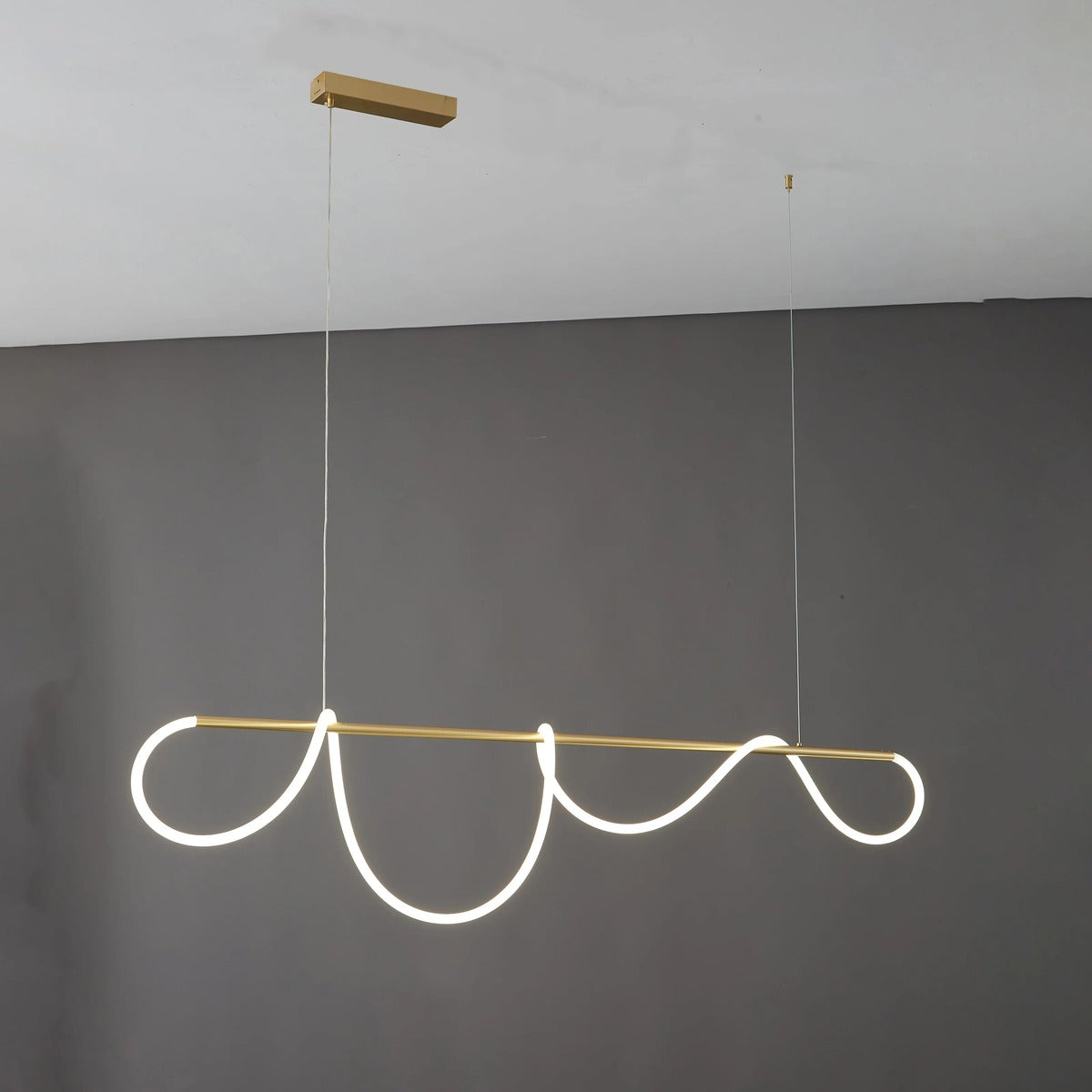 Gold Ondine wave LED linear pendant light, 59.1 in, lit