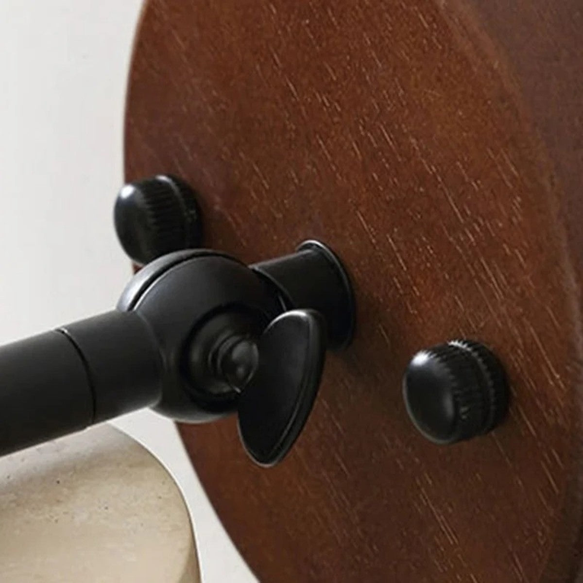 Detail of the Cairn swivel joint between the wood plate and the travertine shade