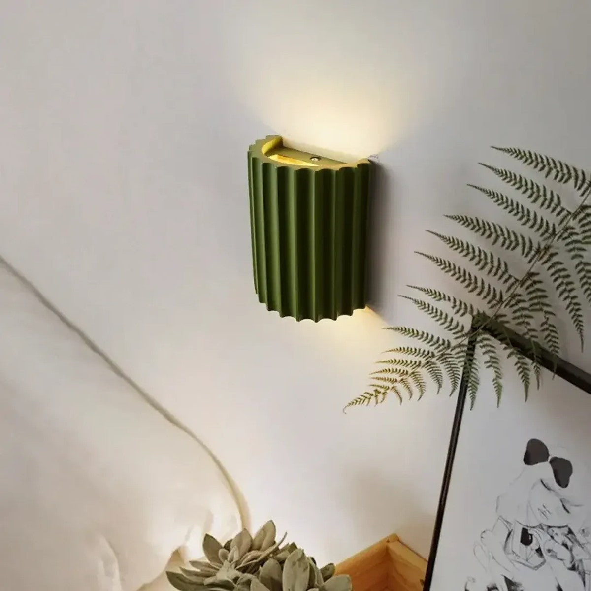Green Nell fluted wall sconce beside a bed