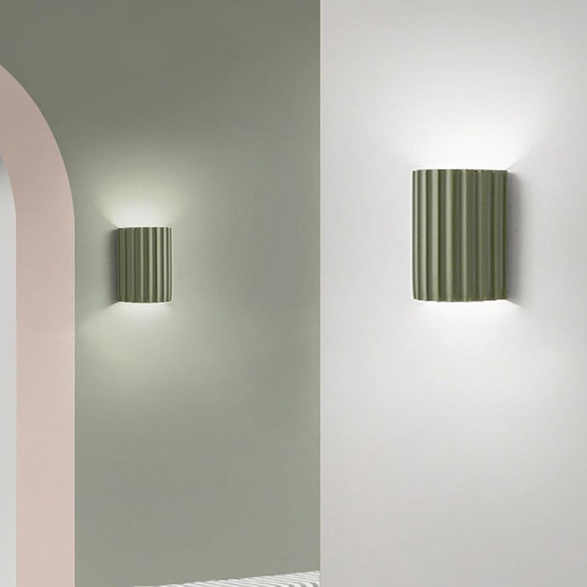 Green Nell wall sconce in a hallway with an arch