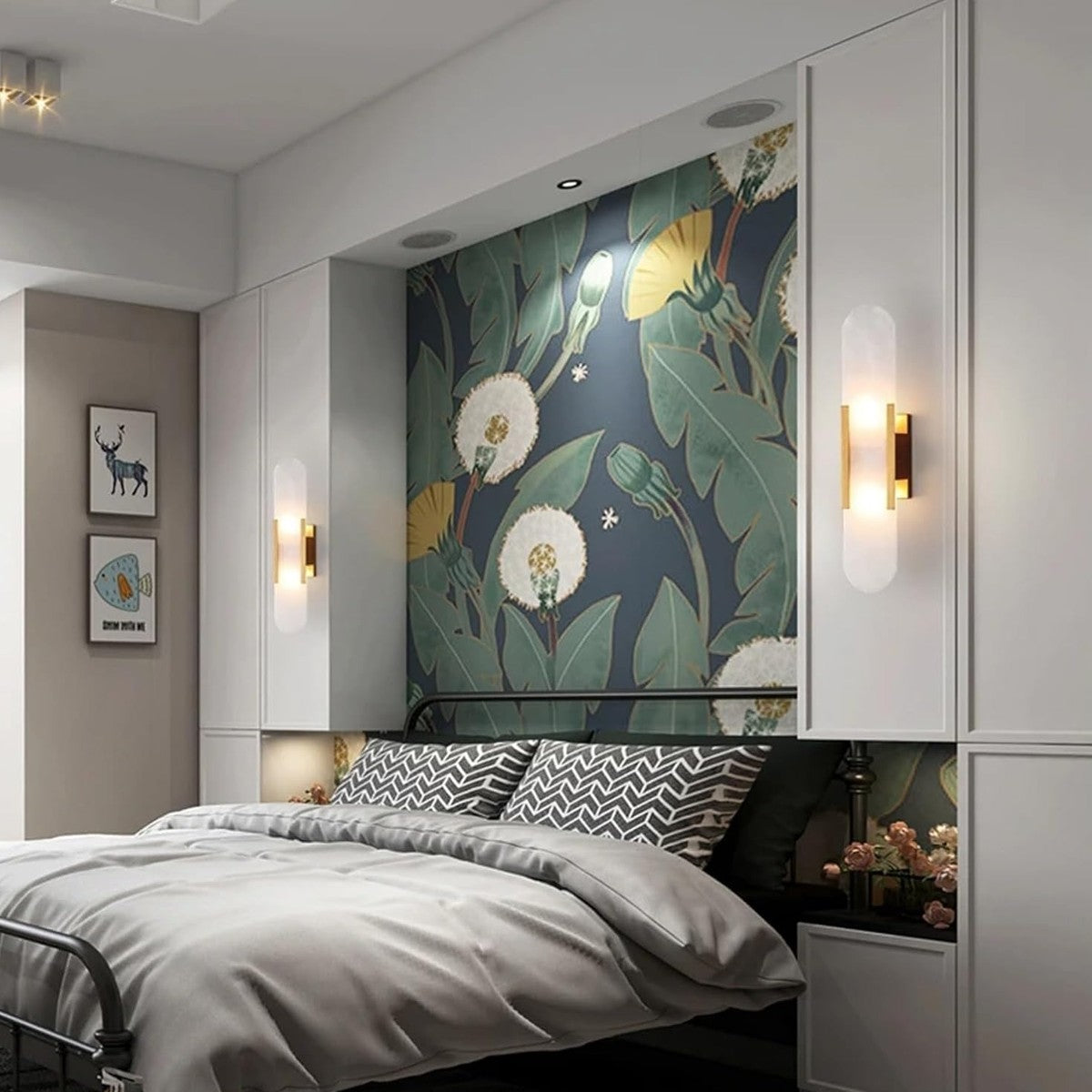 Pair of Pietra gold wall lights in a bedroom
