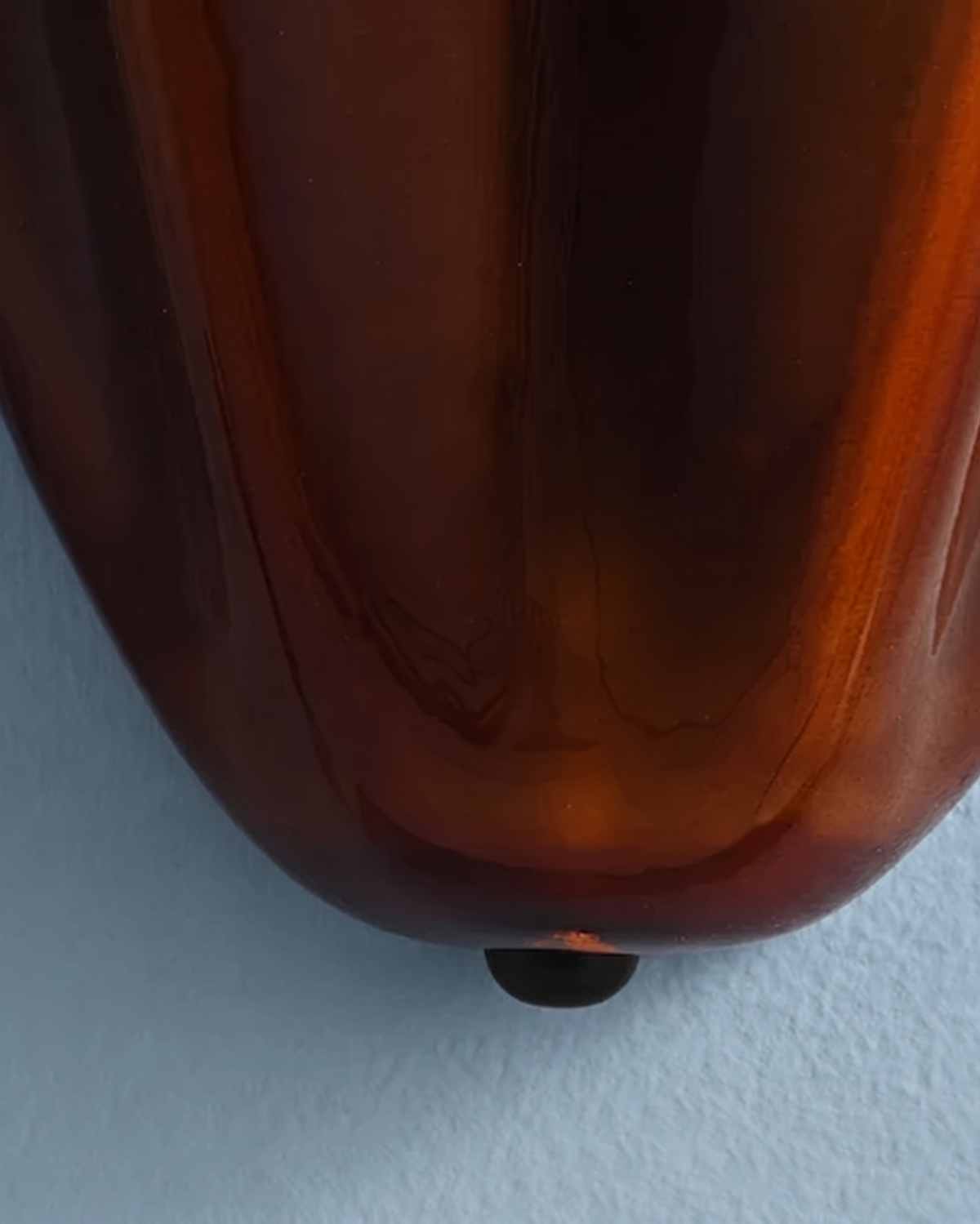Close-up of the amber brown glass of the Calla wall light