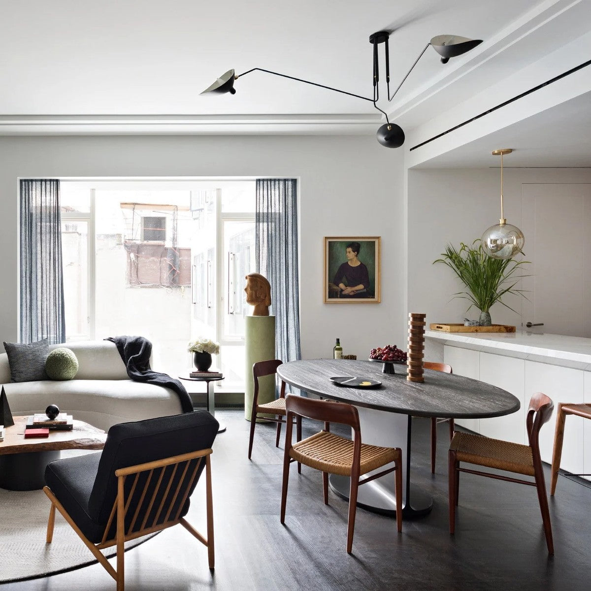 Corella black spider ceiling light in an open-plan dining room