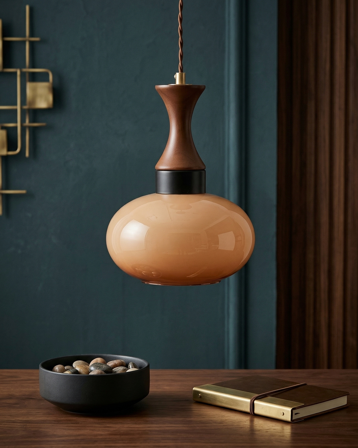 Ovia globe pendant with amber glass against a blue wall