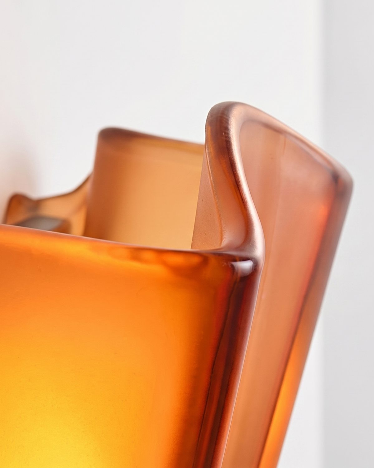 Close-up of the folded edge of the Calla glass shade, lit