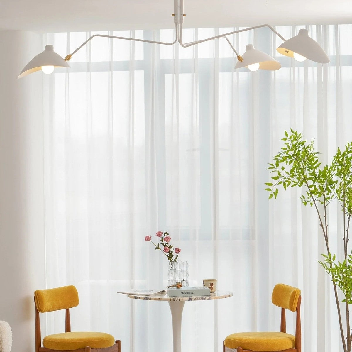 Corella white spider ceiling light above a bistro table