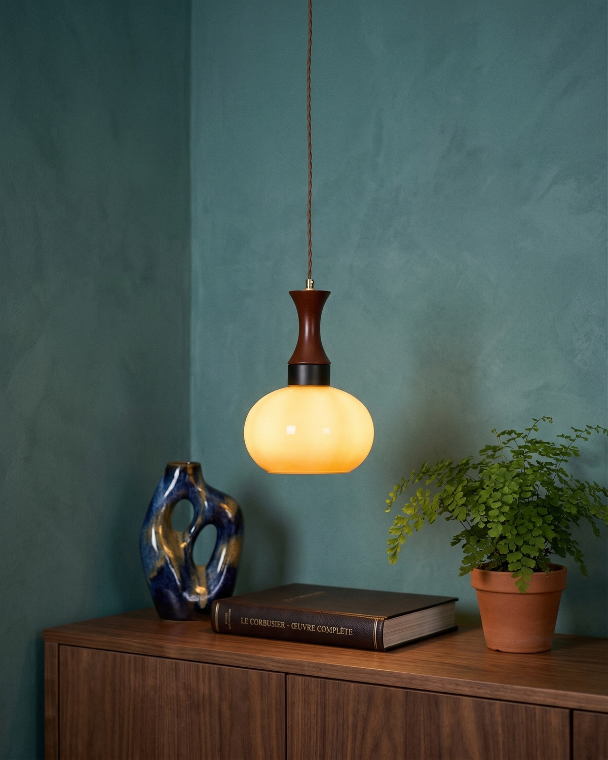 Ovia globe pendant turned on above a sideboard