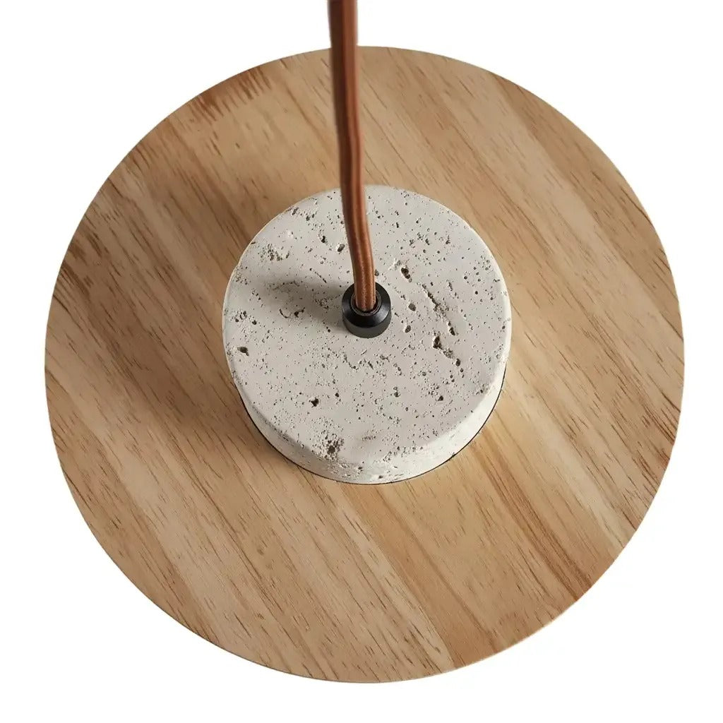 Top view of the Avra travertine cap on its natural wood ring