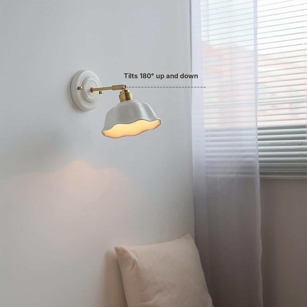 Celia ceramic wall sconce with a shade that tilts 180 degrees up and down