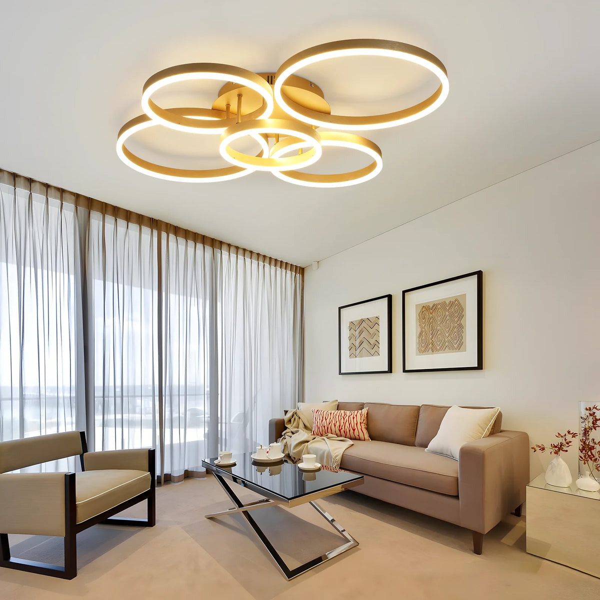 Circle LED ring flush mount ceiling light in gold, interlocking rings glowing warm white over a modern living room