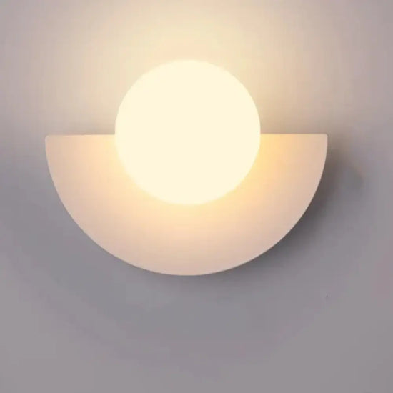 Cleo semicircle globe wall sconce in white with warm light