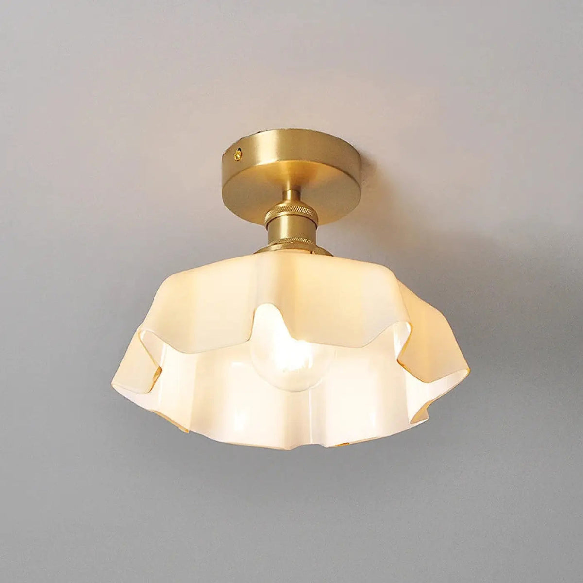 Fleur scalloped glass semi-flush ceiling light in cream with brass-finish mount