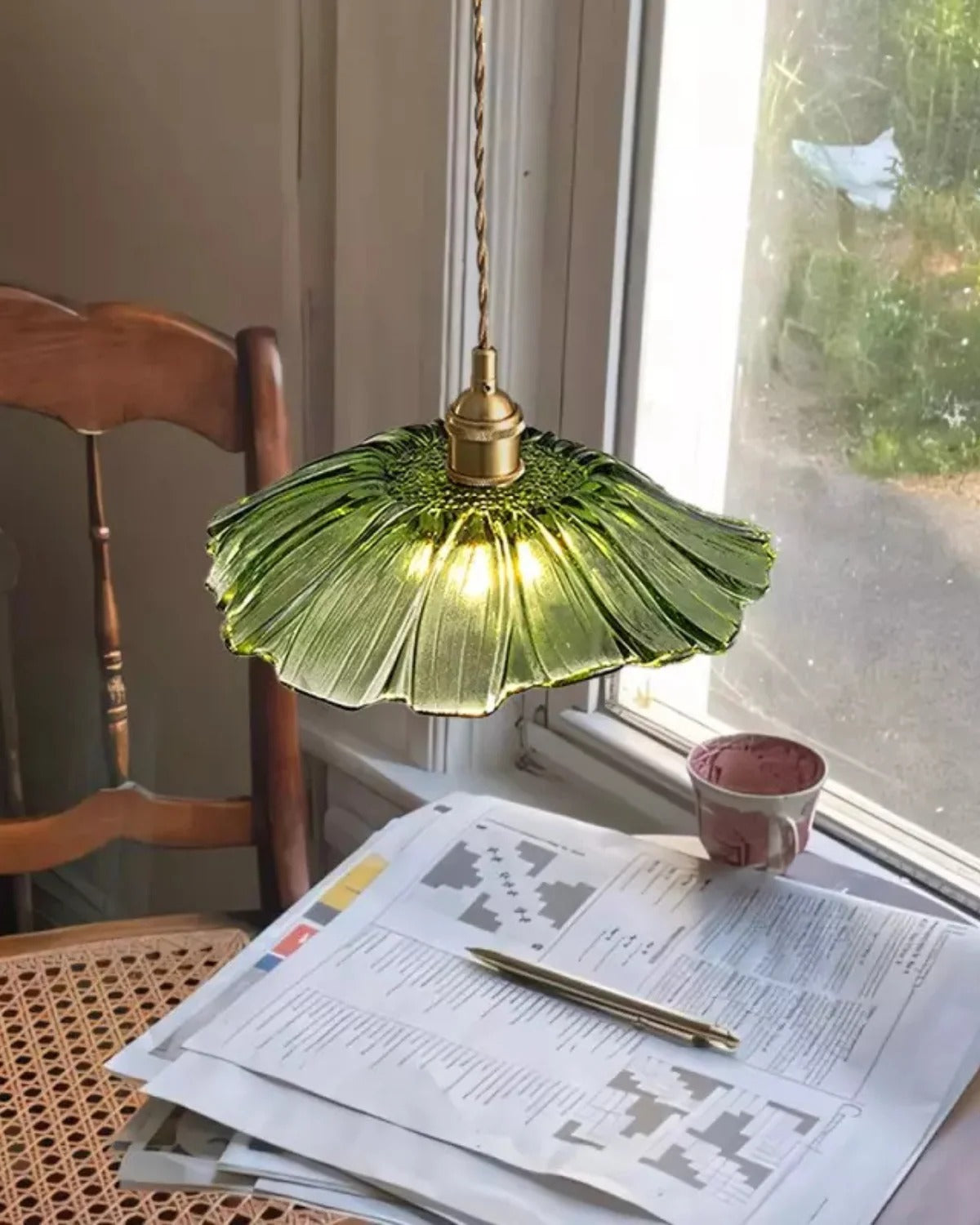 Flora green flower glass pendant in a reading nook by the window