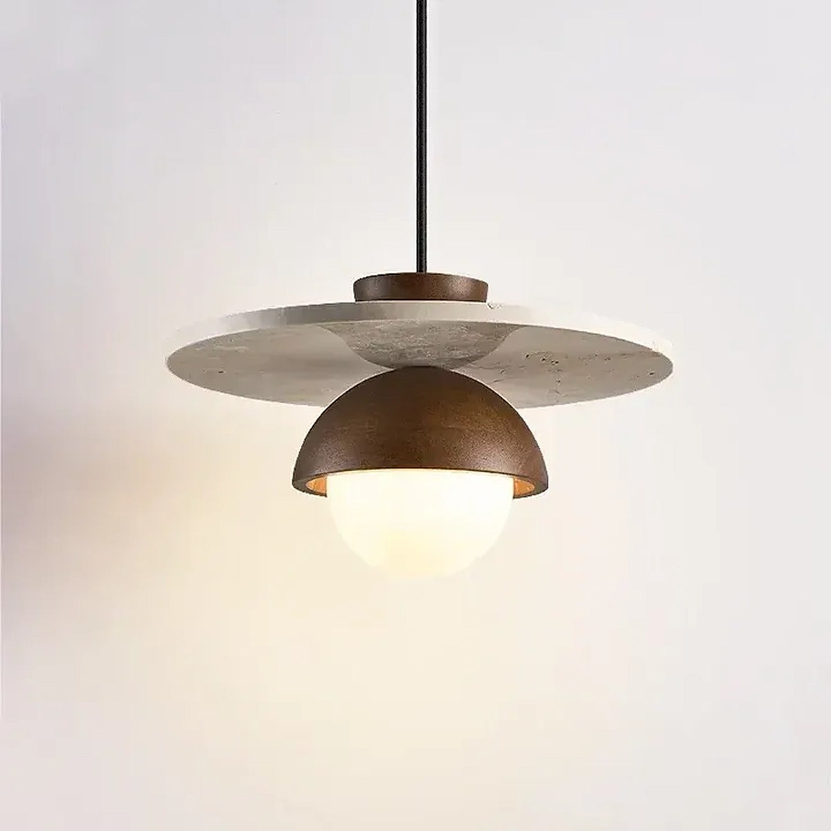 Side view of the Luna pendant light showing the slim travertine disc
