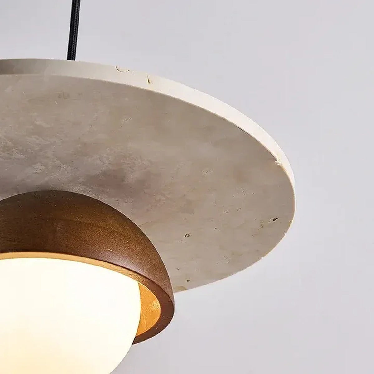 Detail of the natural travertine pores on the Luna pendant disc