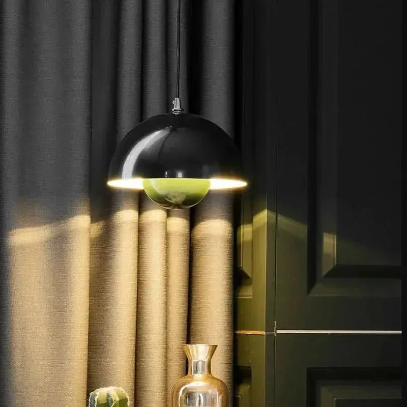 Black Nola mushroom pendant light lit in front of a curtain