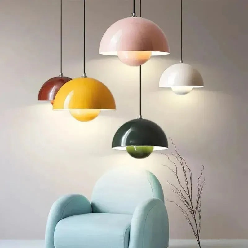 Nola mushroom pendant lights in yellow, pink, white, green and red above an armchair