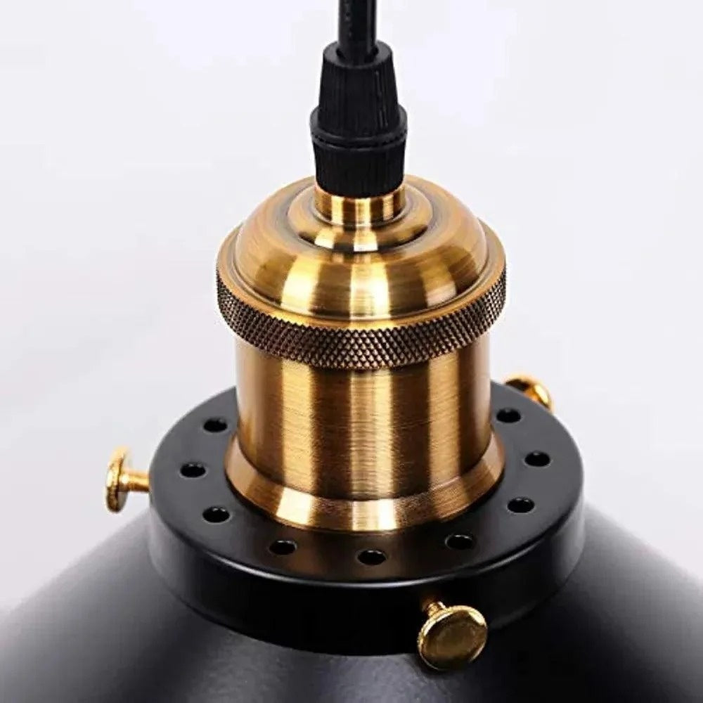Close-up of the Orrin pendant's knurled antique-brass socket on the black metal shade