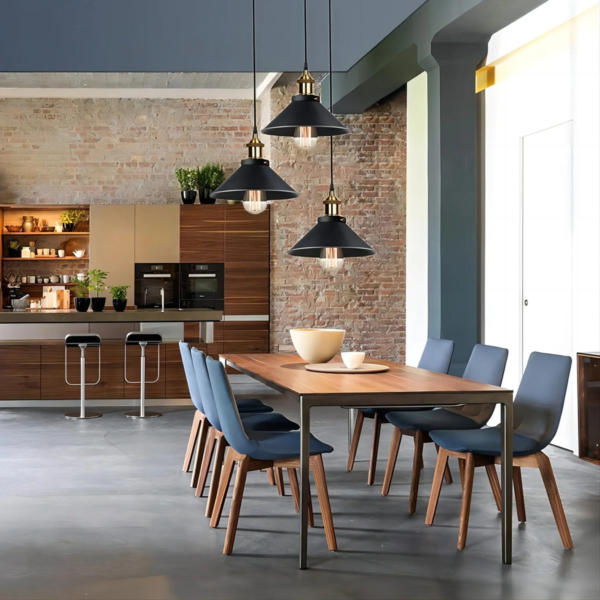 Orrin black cone pendant cluster over a wood dining table in a brick-wall loft kitchen