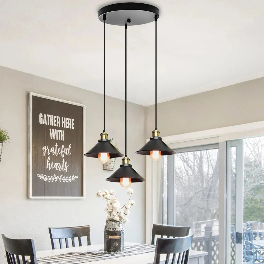 Orrin round canopy 3-light pendant with staggered black shades over a farmhouse dining table
