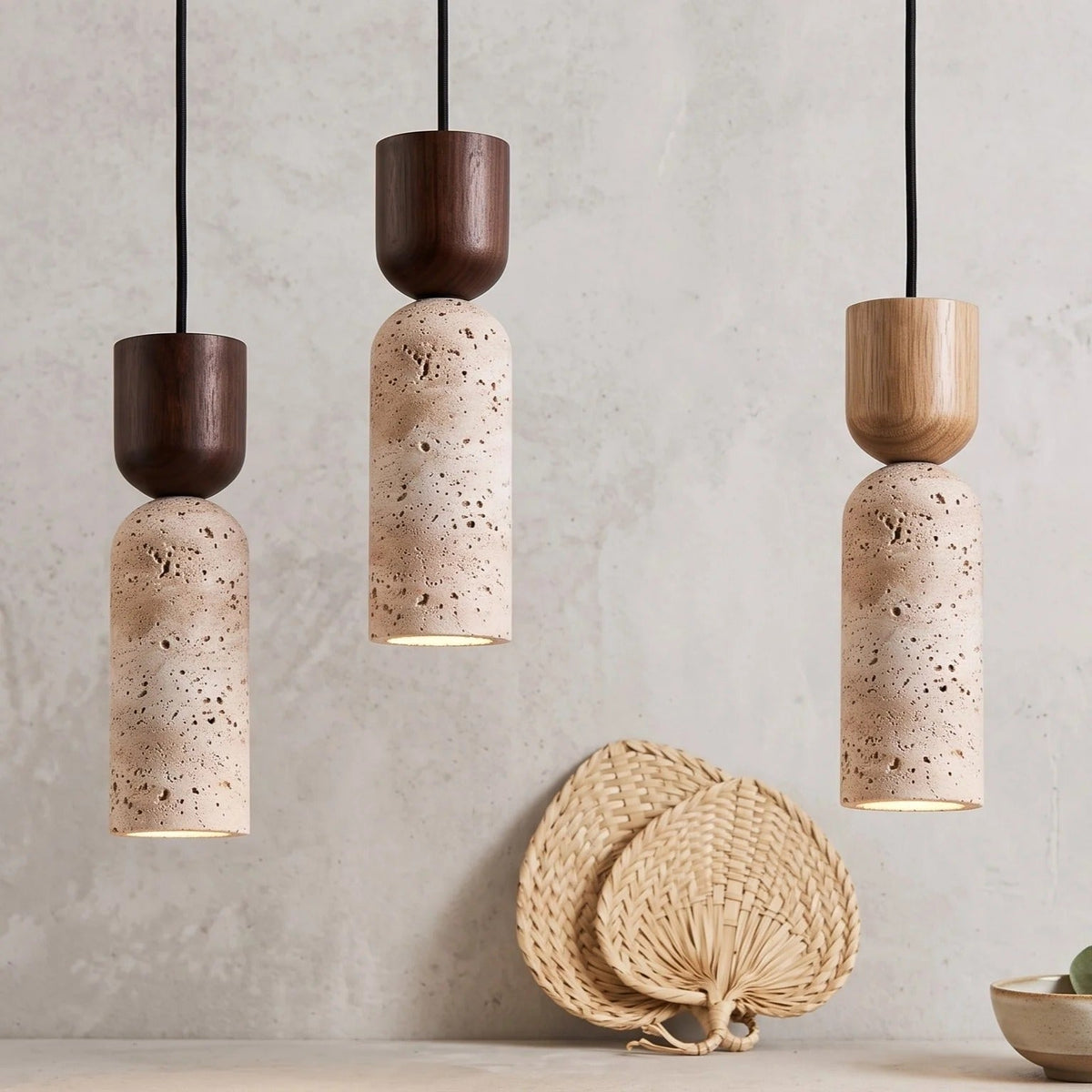 Three Pia travertine mini pendant lights in walnut and light wood finishes