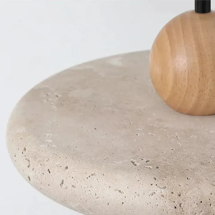 Close view of natural travertine pores and the wooden sphere