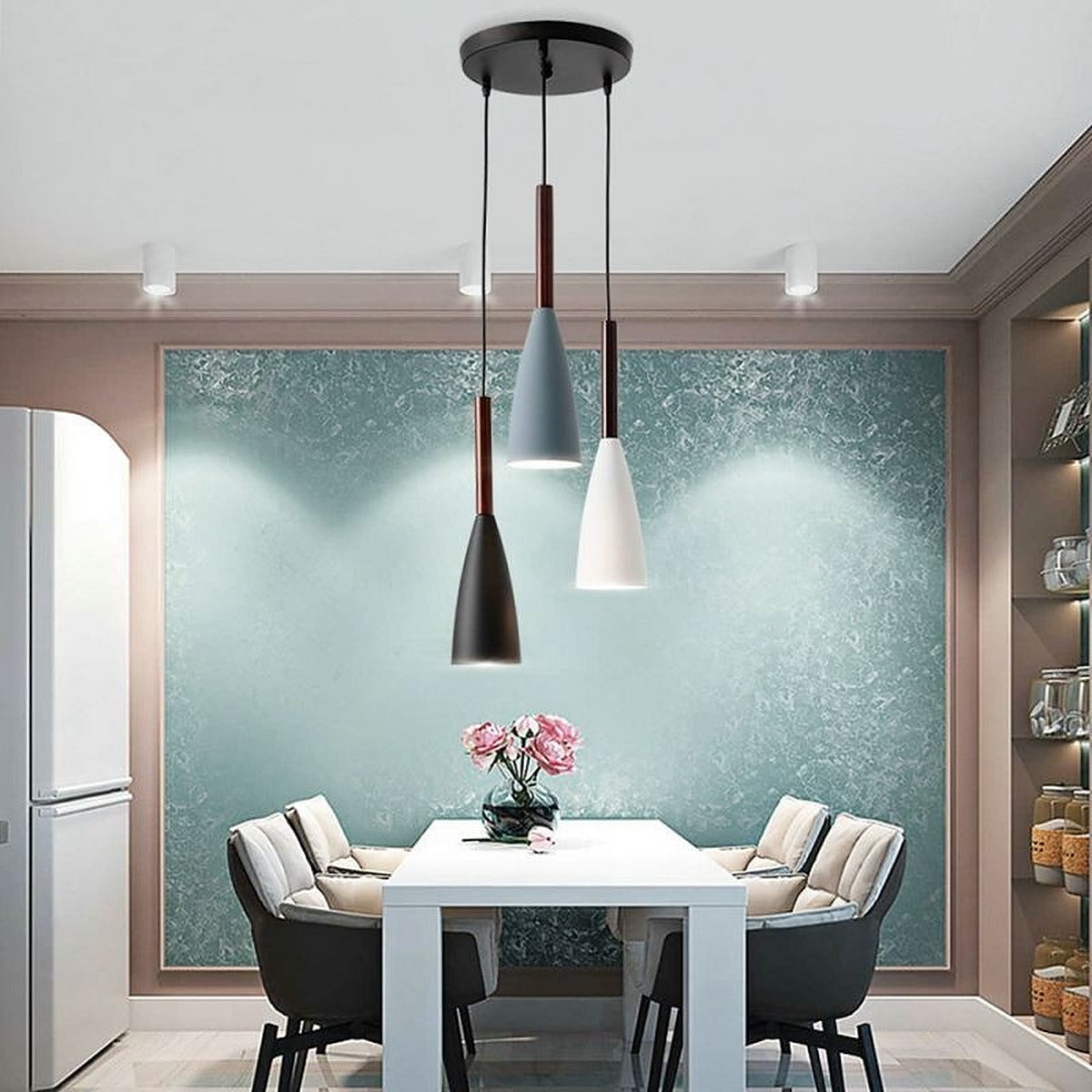 Vika 3-light round pendant over a white dining table with gray chairs