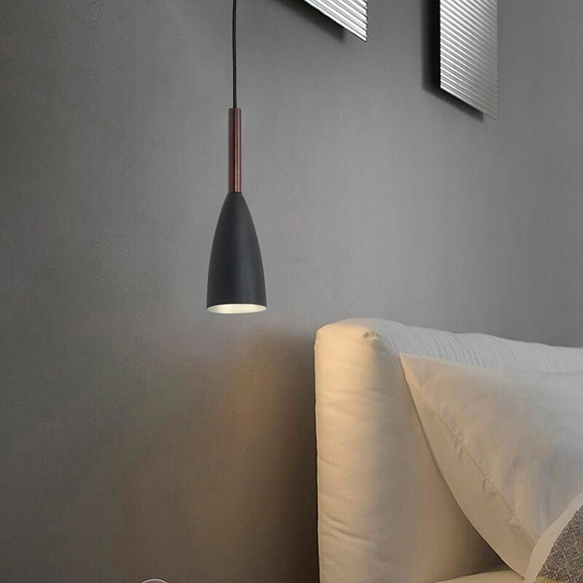Single black Vika slim pendant light with wood neck hanging as a bedside light
