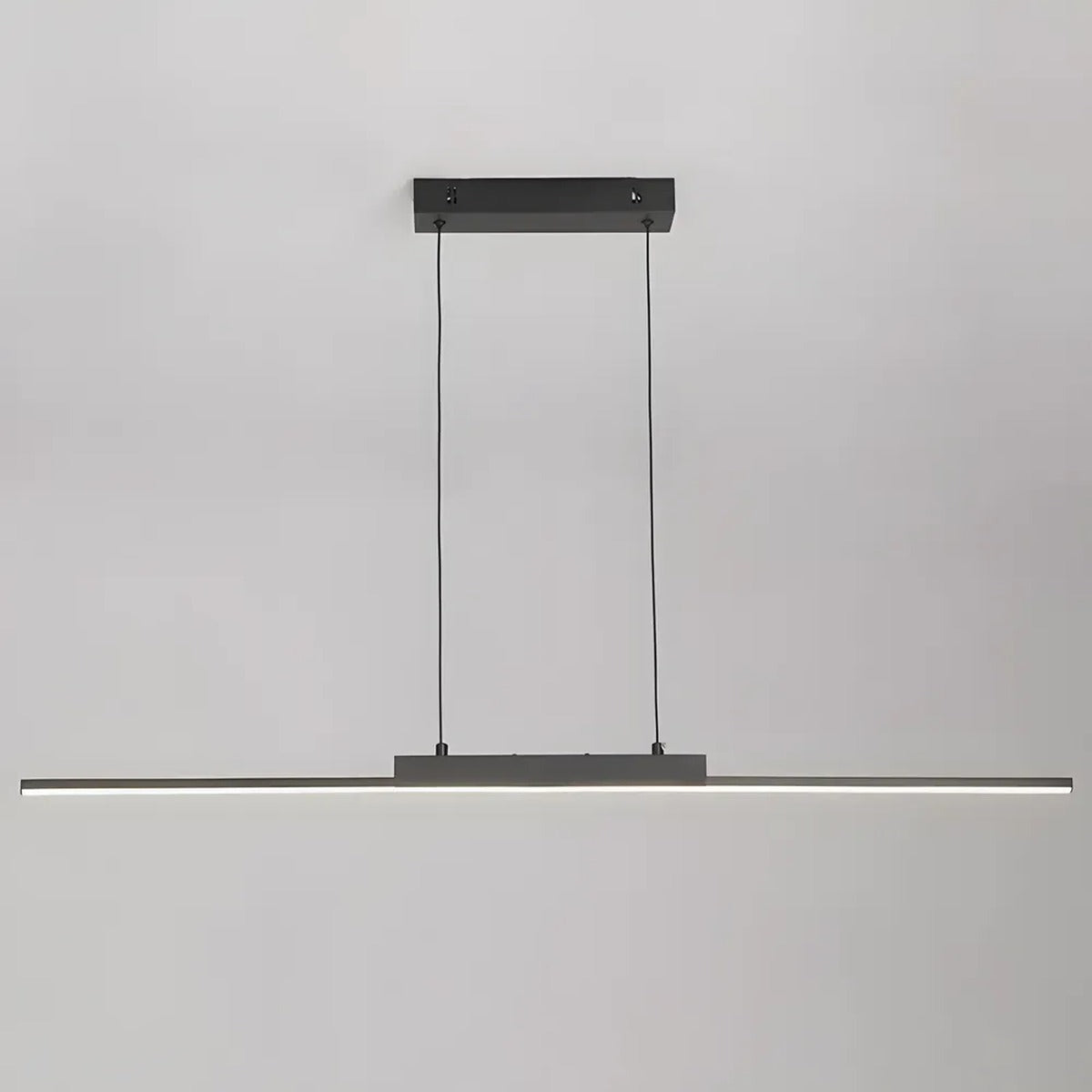 Elio linear LED pendant light in matte black, slim bar on two suspension wires