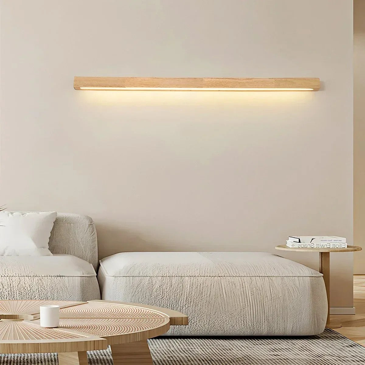 Kauri linear LED wall light in natural wood finish above a sofa