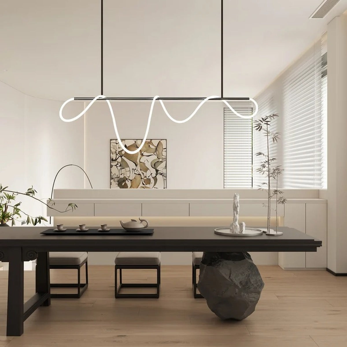 Black Ondine wave LED linear pendant light over a wood tea table
