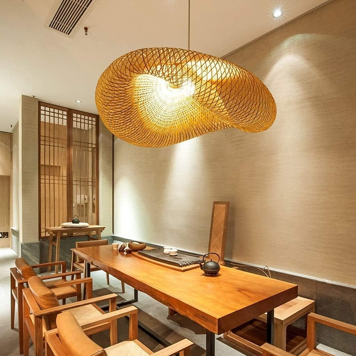 Nami woven bamboo pendant light above a long timber table