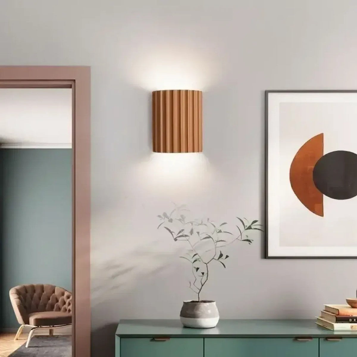 Terracotta Nell fluted wall sconce above a sideboard in a hallway