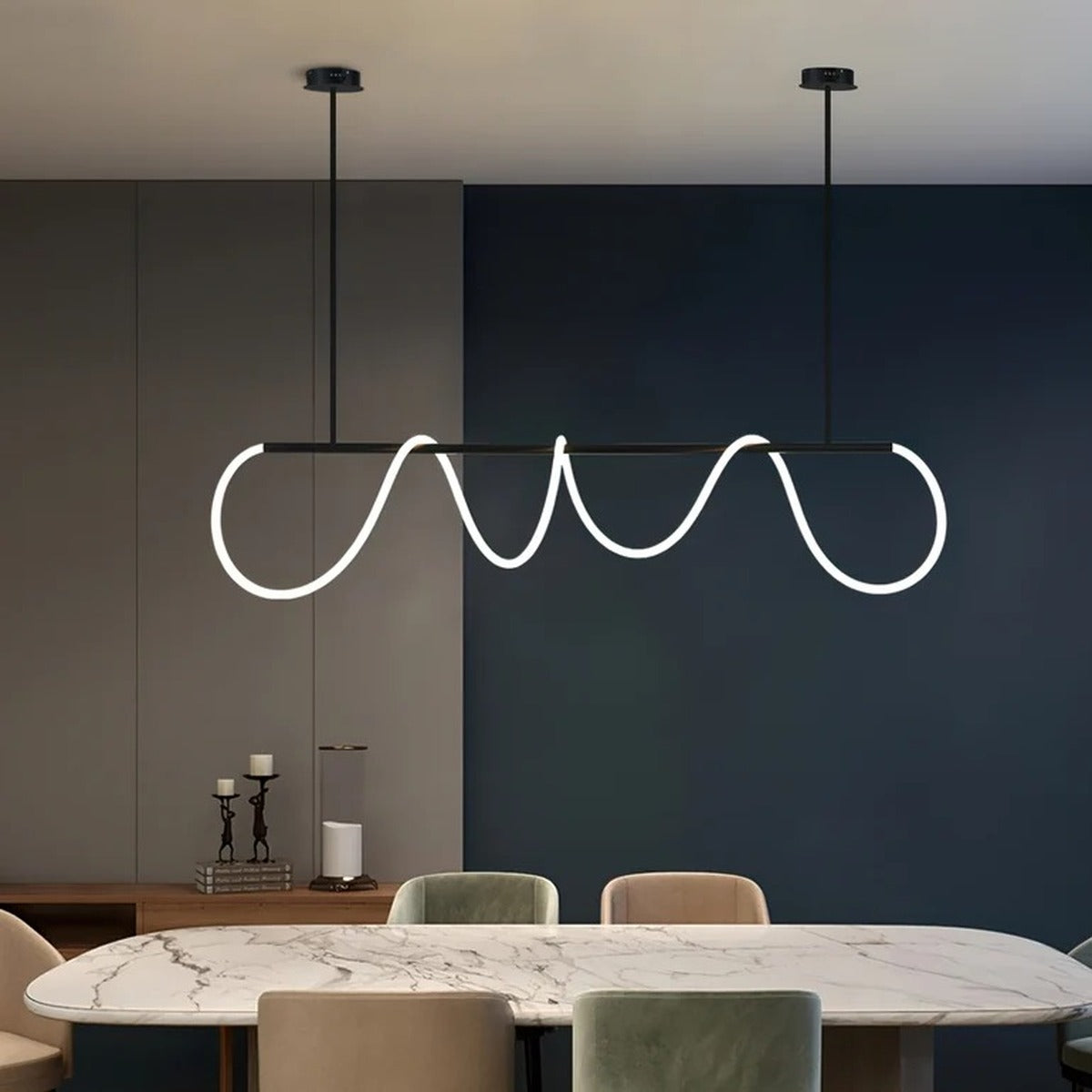 Black Ondine wave LED linear pendant light above a marble dining table
