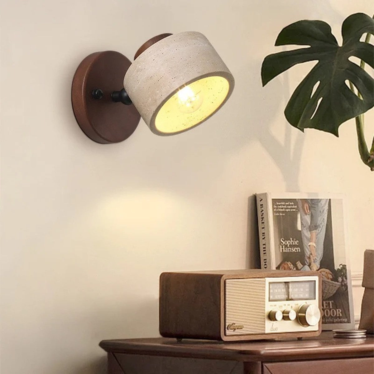 Cairn walnut travertine wall sconce used as a reading light in a nook