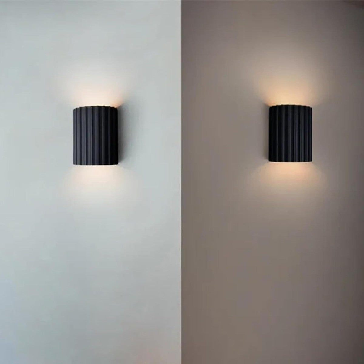 Pair of black Nell wall sconces casting up and down light