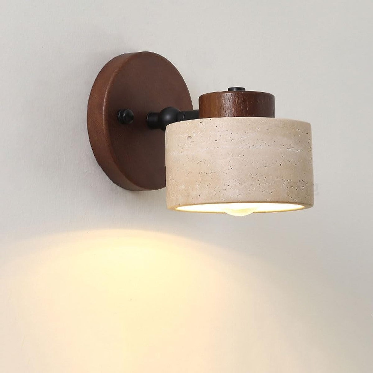 Side view of the lit Cairn walnut wall sconce showing the swivel arm