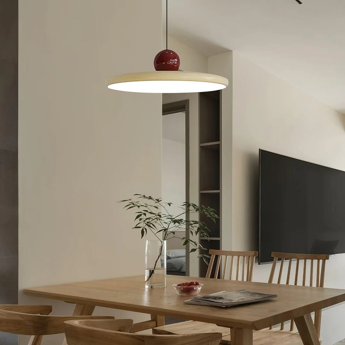 Cream and red Juno saucer pendant light over a timber dining table
