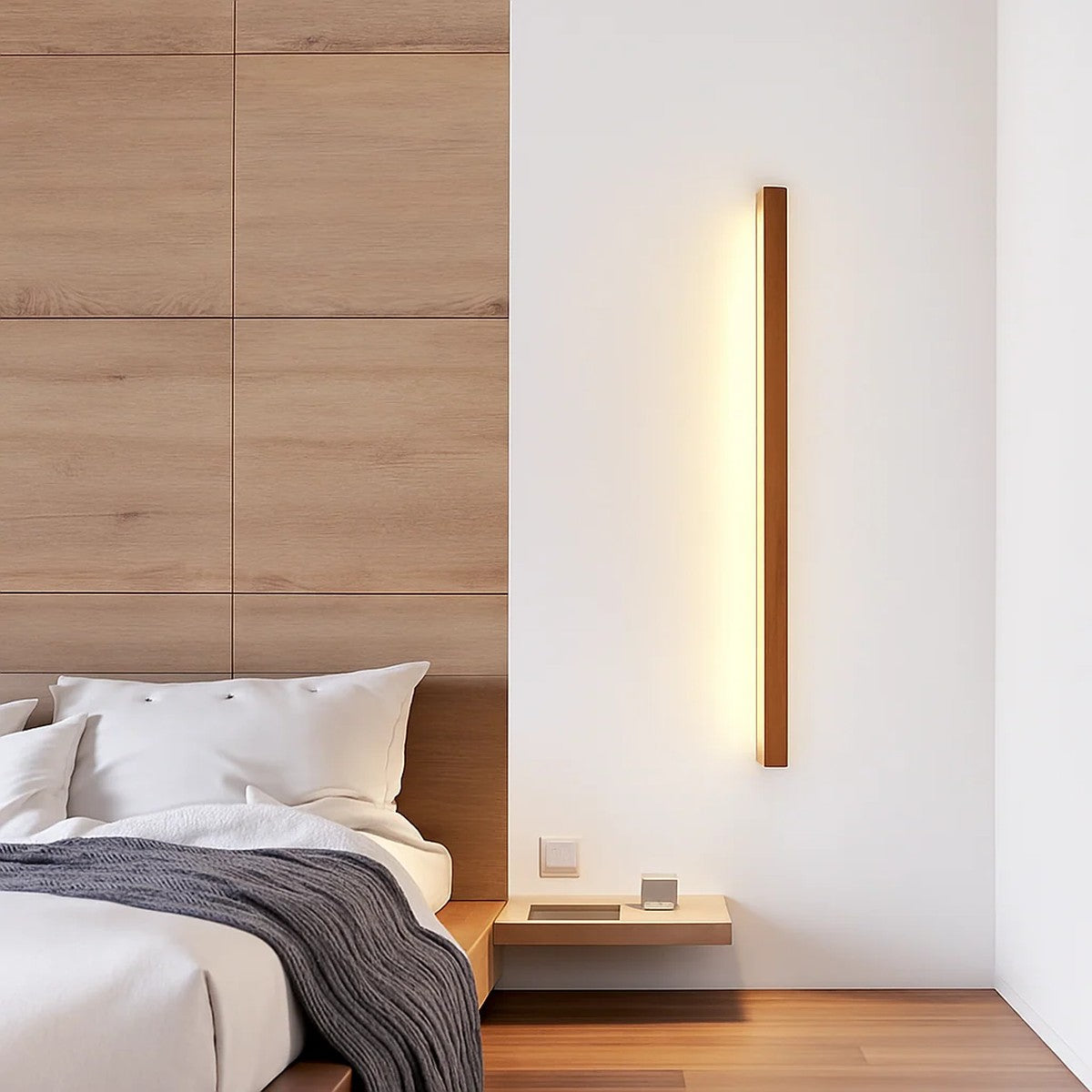 Kauri walnut linear wall light mounted vertically beside a bed