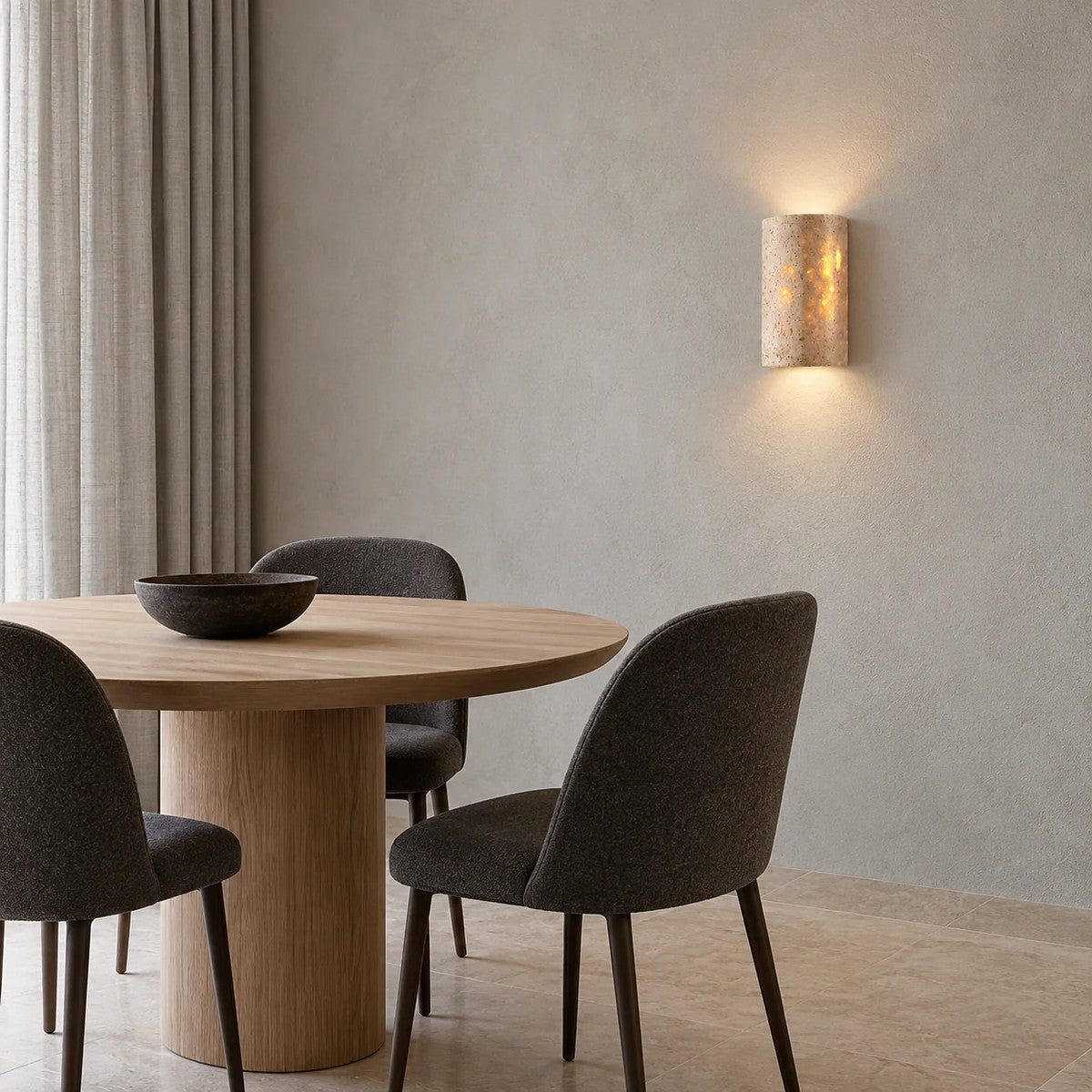 Talia travertine wall sconces in a dining room