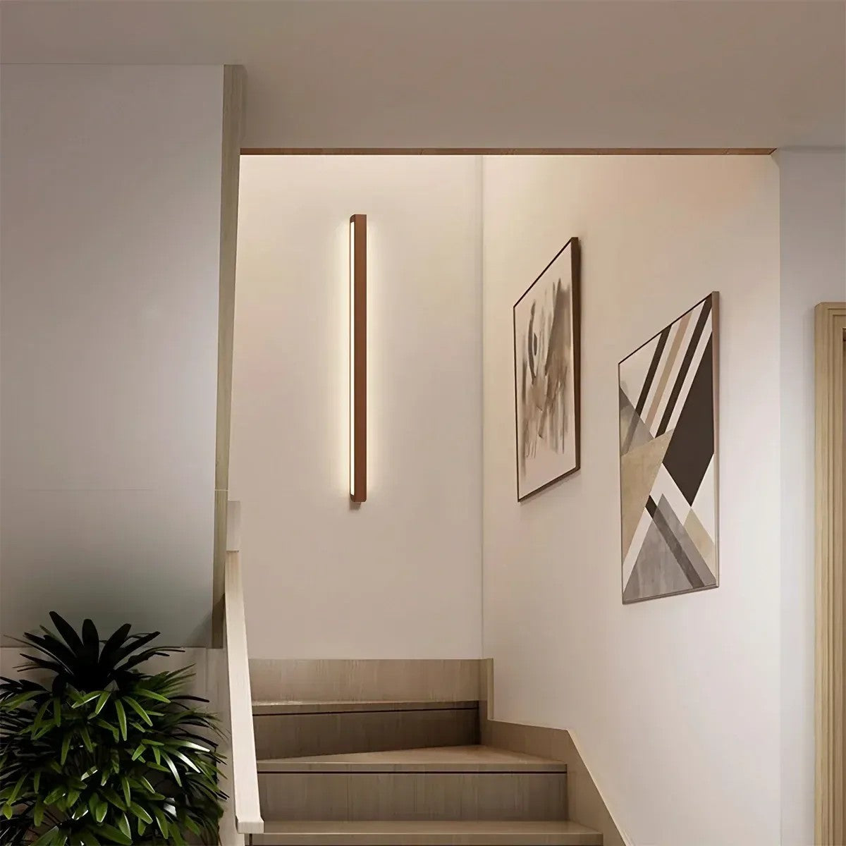 Kauri walnut linear wall light mounted vertically in a stairwell