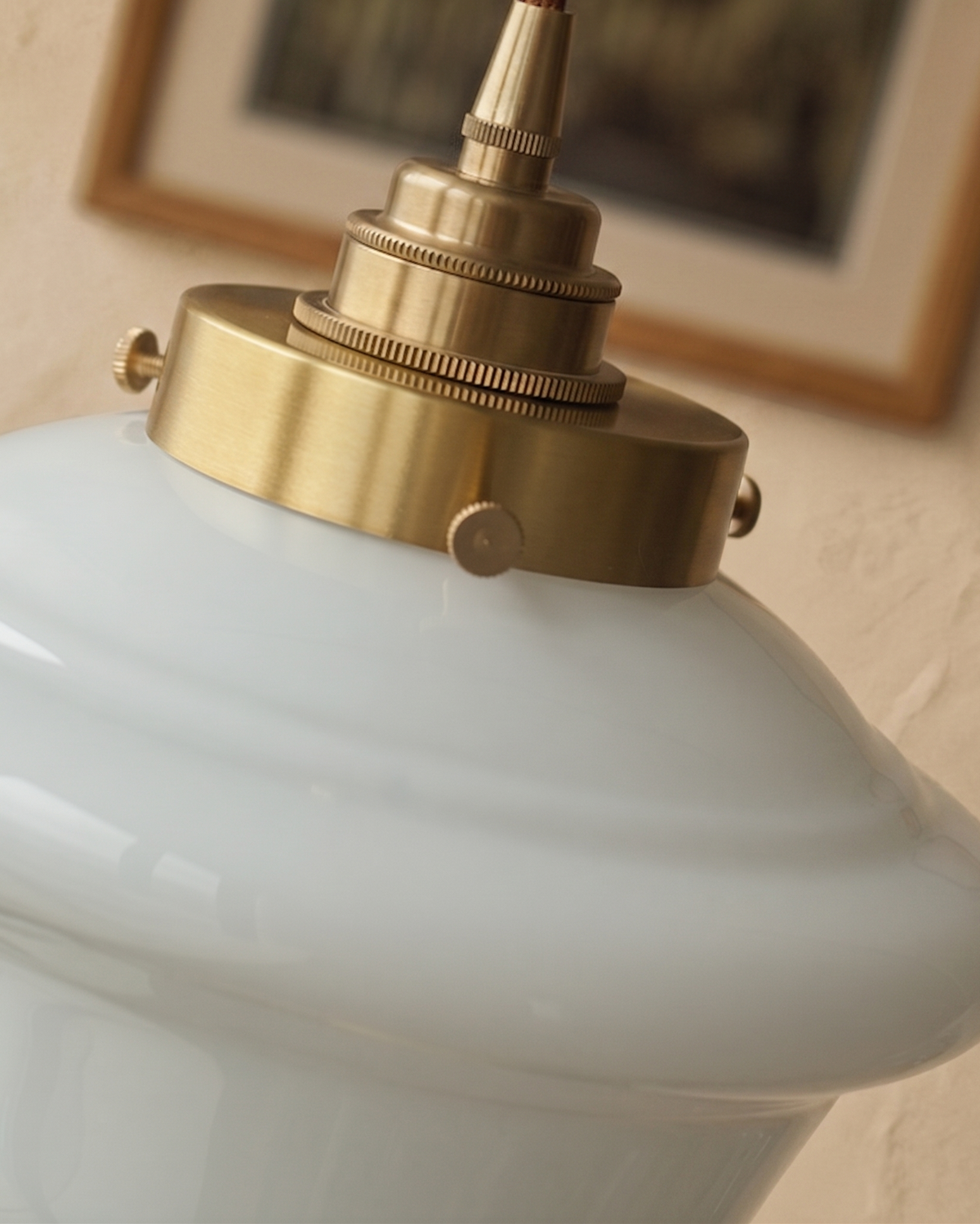 Close-up of the brass gallery and screws on the Elsie milk glass shade