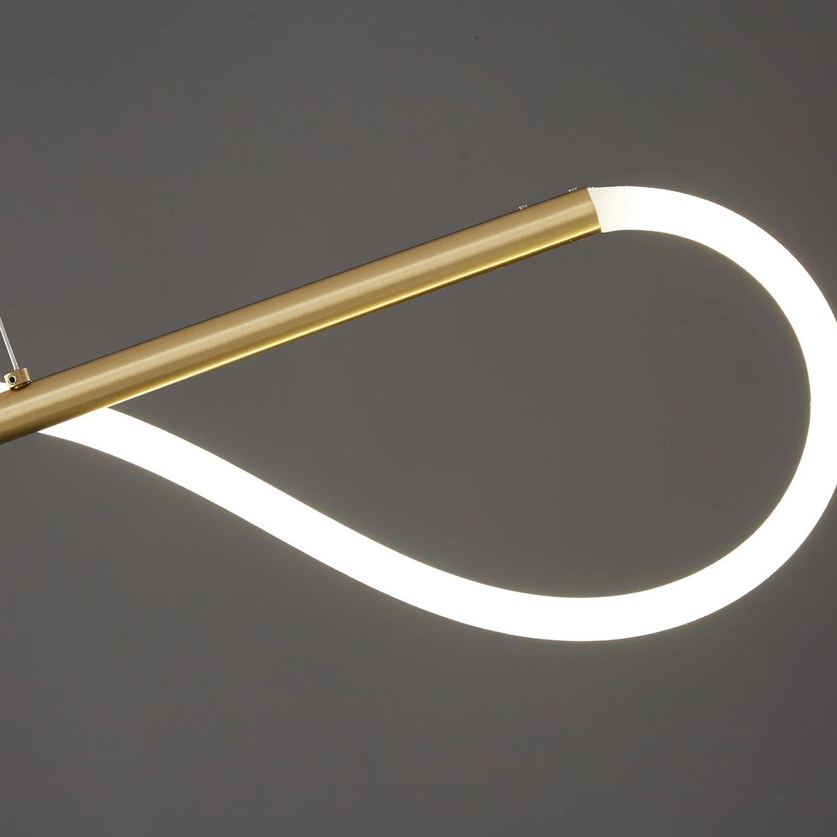Close-up of the gold bar and soft glowing LED tube of the Ondine pendant