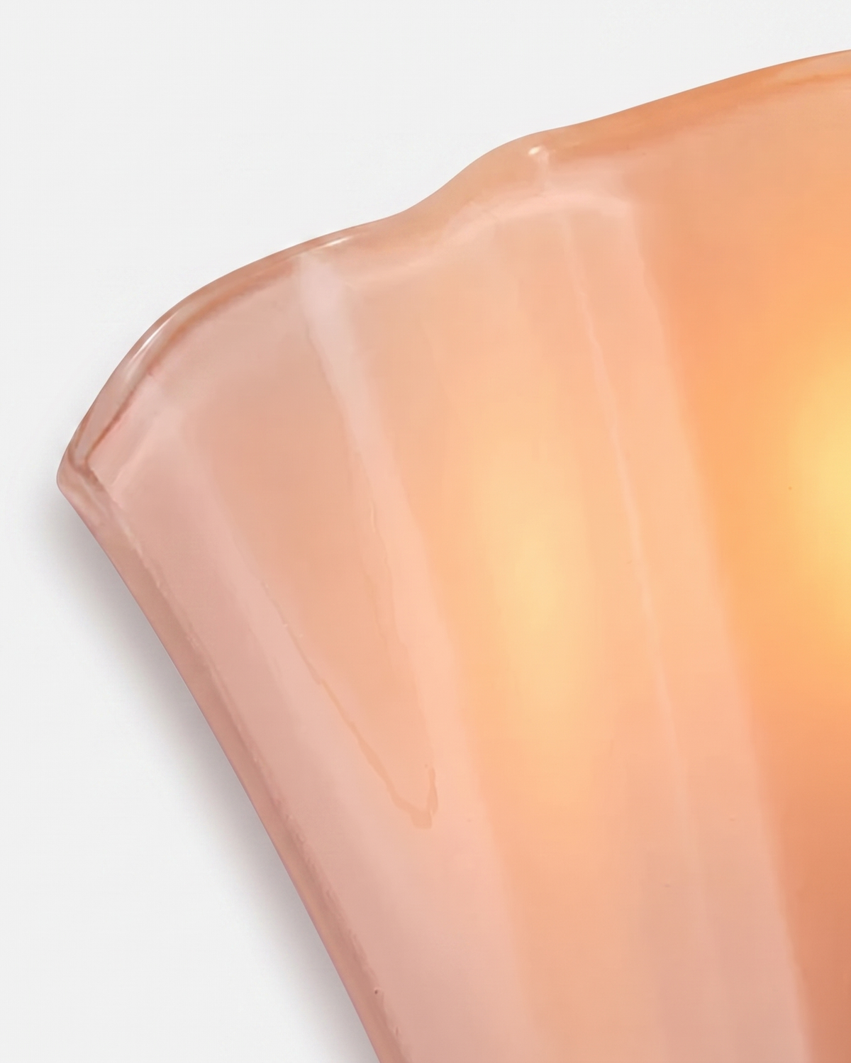 Close-up of the ruffled edge of the blush pink Calla wall light