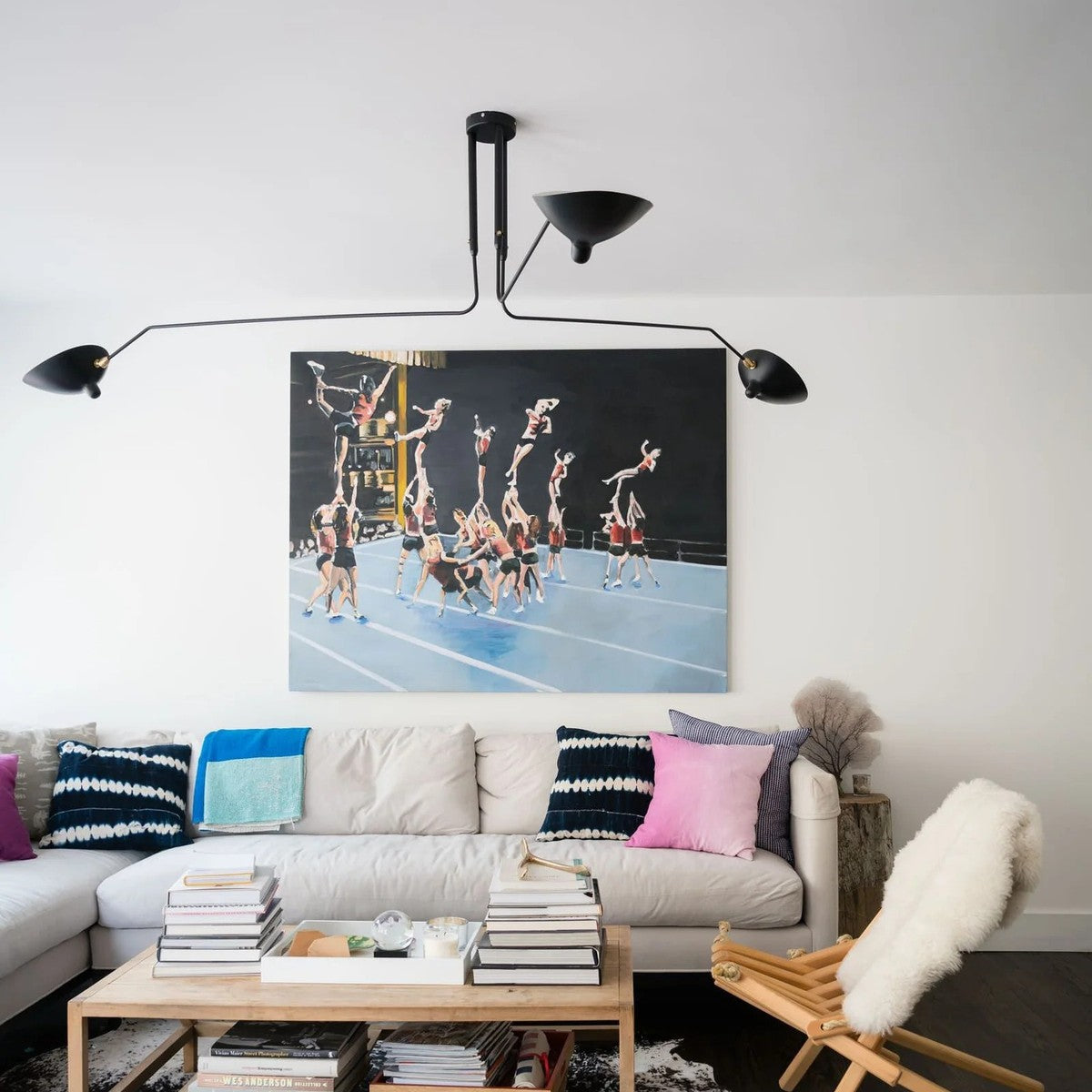 Corella black spider ceiling light above a sofa