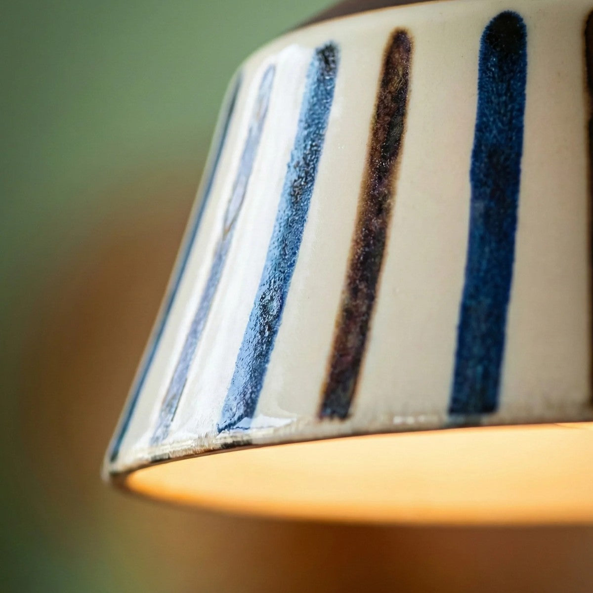 Macro of the hand-painted blue and brown stripes on the Hana ceramic shade