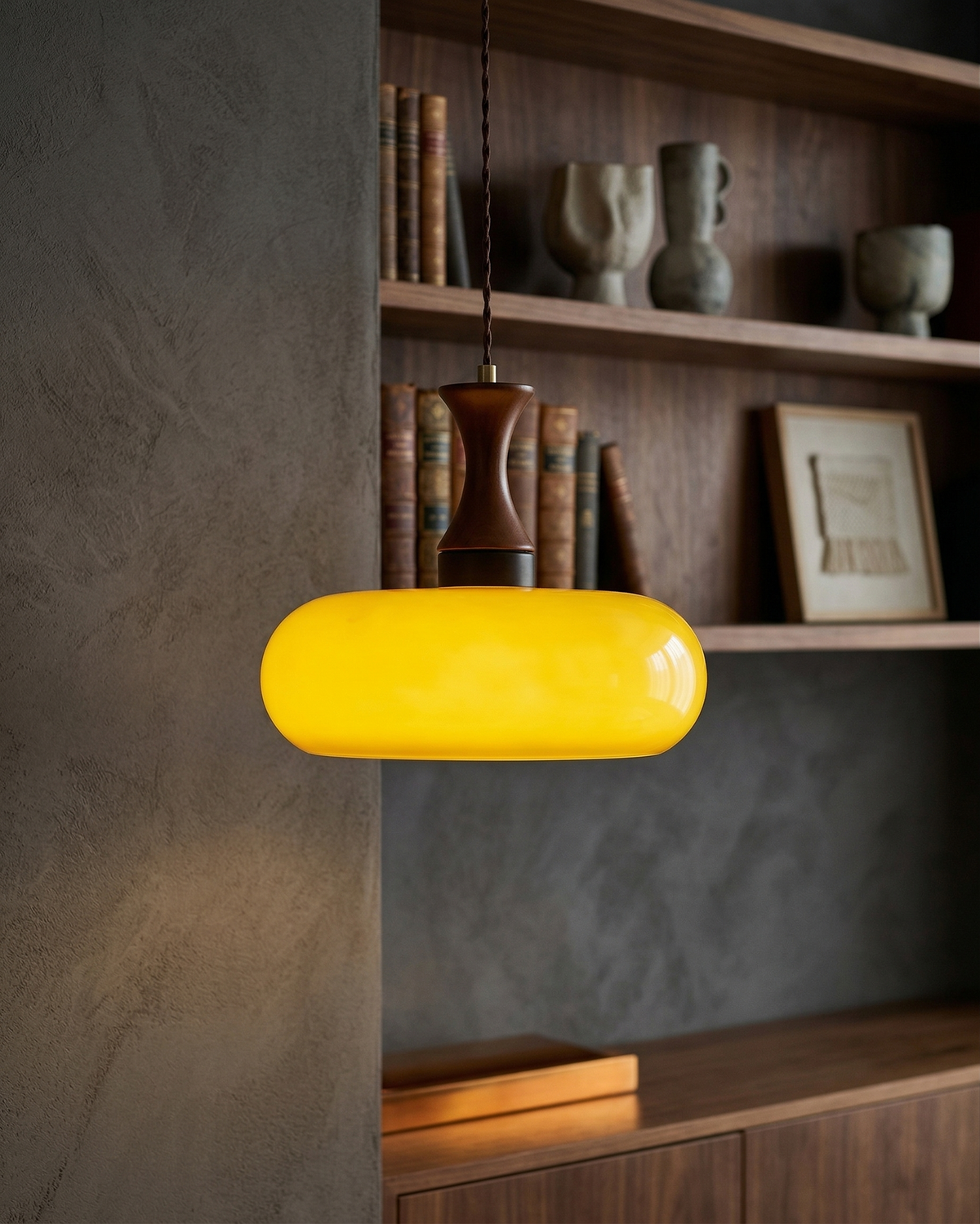 Ovia saucer pendant turned on with a warm amber glow